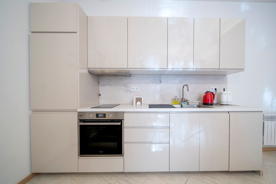 Biały aneks kuchenny w apartamencie typu Superior
